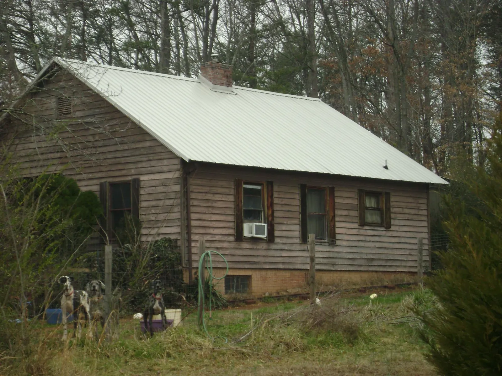 White metal roof on an old wood sided farmhouse, from a Asphalt Shingle Roof Repair job in Roanoke